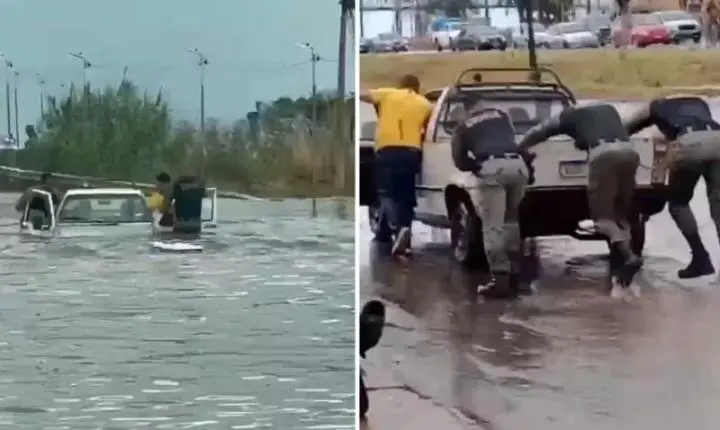 Policiais entram em enchente para resgatar casal ilhado dentro de carro em Goiás